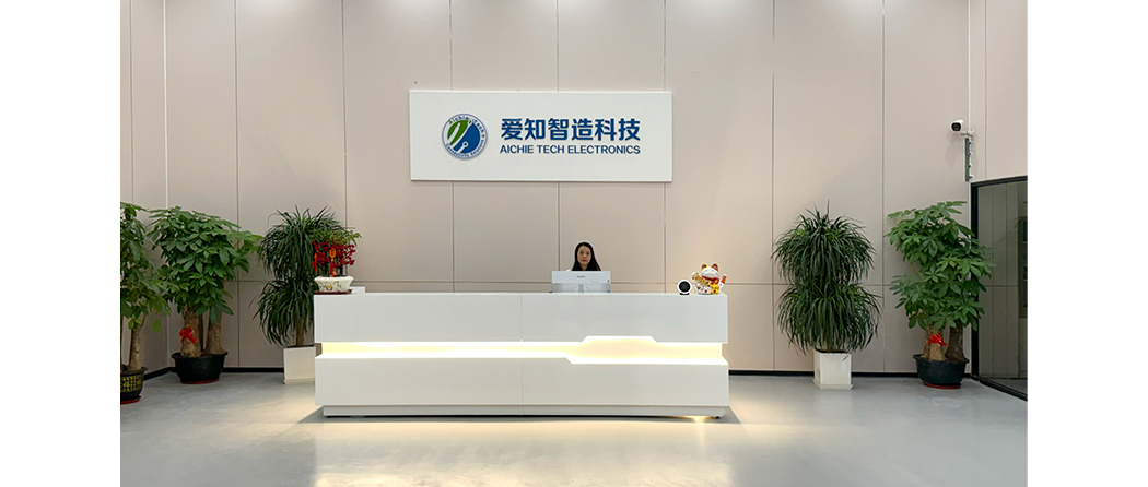 Welcoming reception area with company logo wall, modern front desk, and professional staff ready to assist visitors.